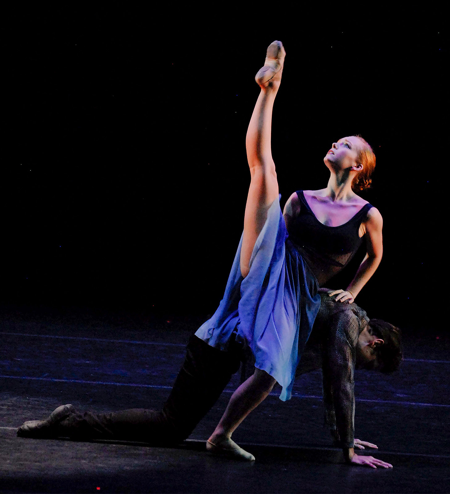 a man and woman dancing on stage