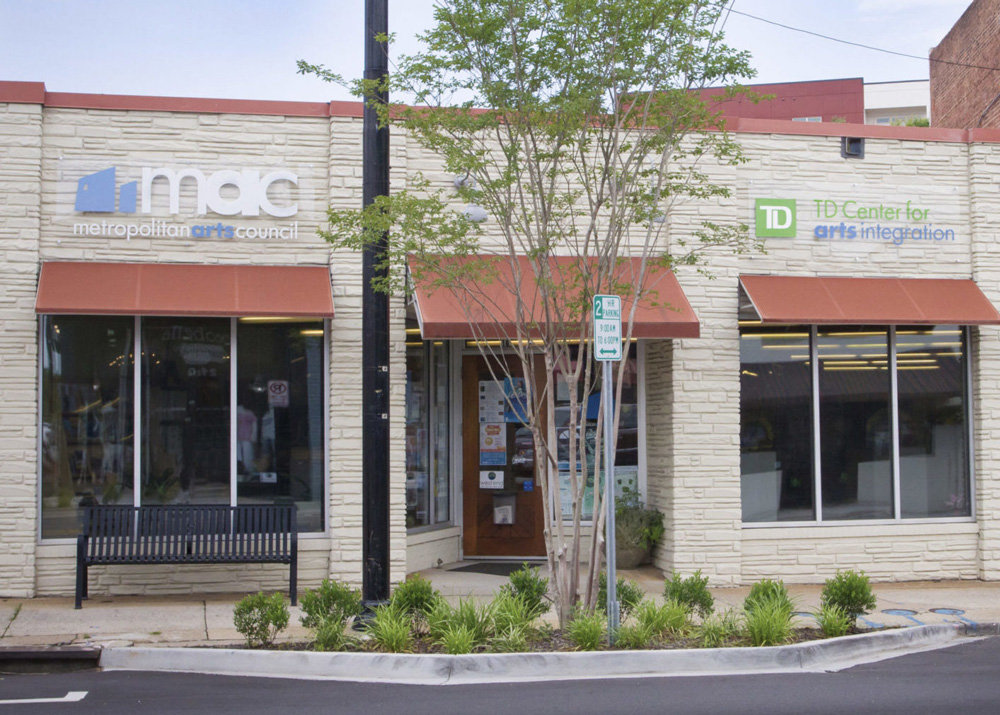 a building with a tree and a bench