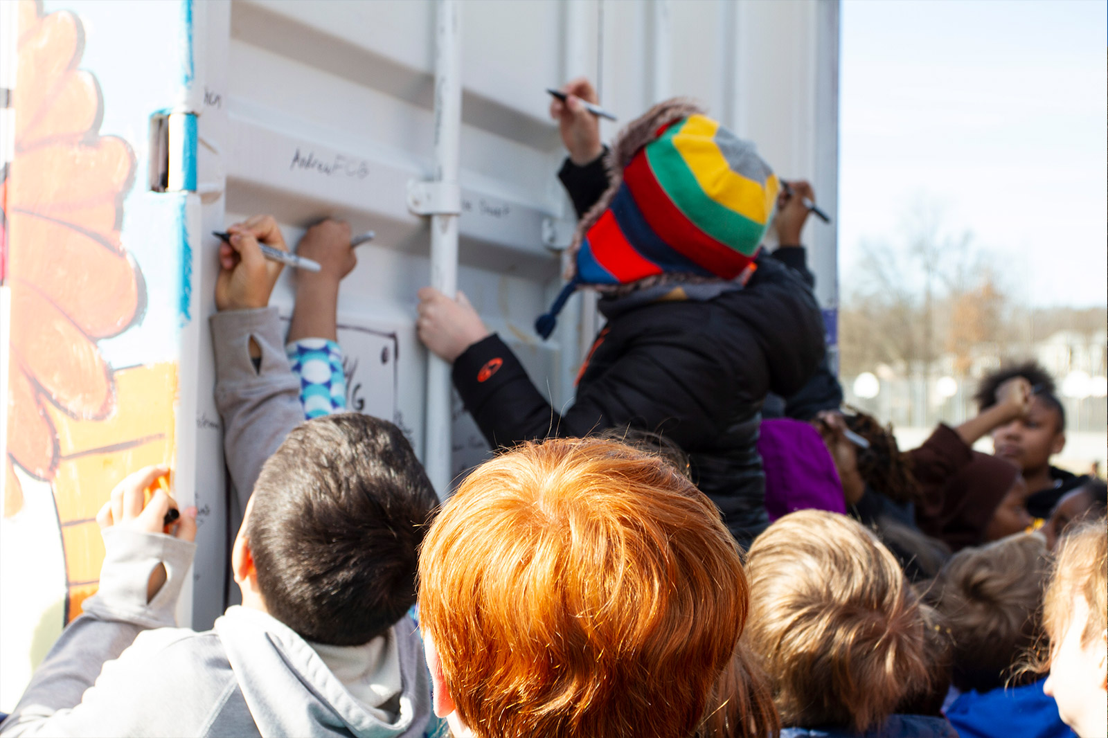 a group of people writing on a wall