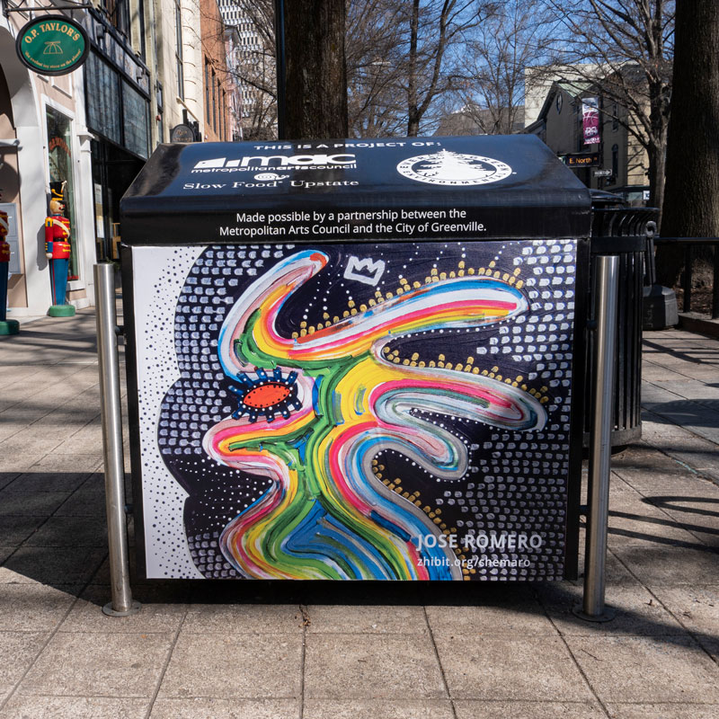 a trash can with a colorful painting on it