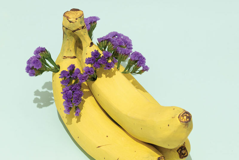 a bunch of bananas with purple flowers