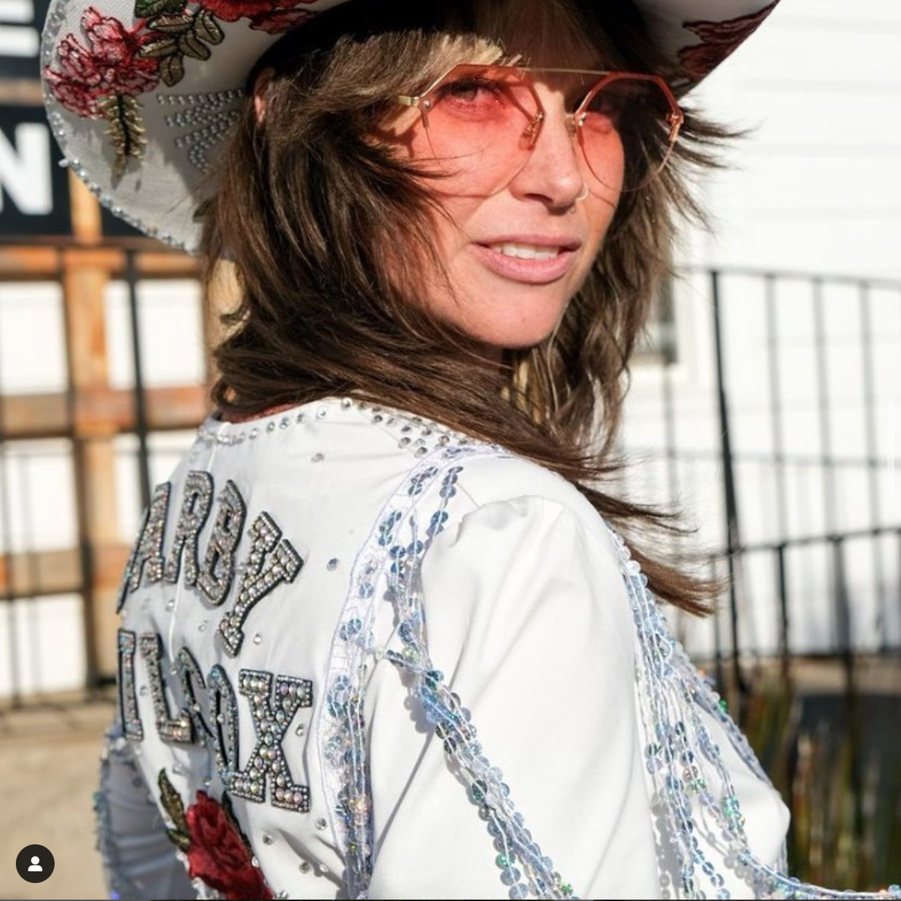 a woman wearing a cowboy hat and sunglasses