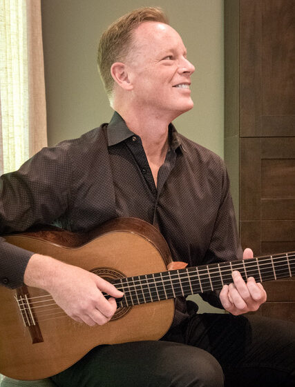 a man holding a guitar