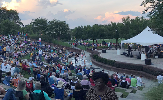 a group of people sitting in a park