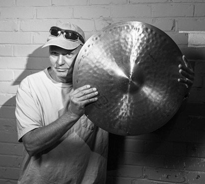 a man holding a cymbal