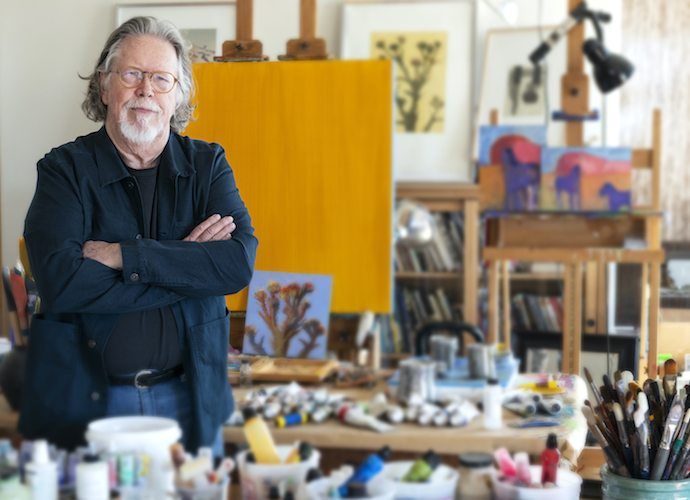 A man standing in a painting studio in Greenville, SC.