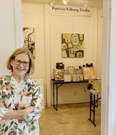 a woman standing in a room with art