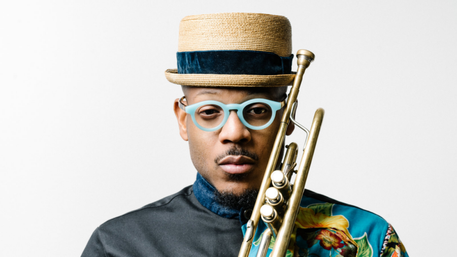 a man wearing a hat and glasses holding a trumpet