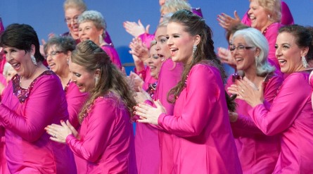 a group of women in pink dresses