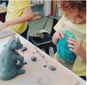 a child sculpting a sculpture