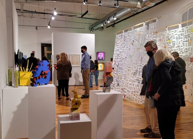 people in a room with art and people