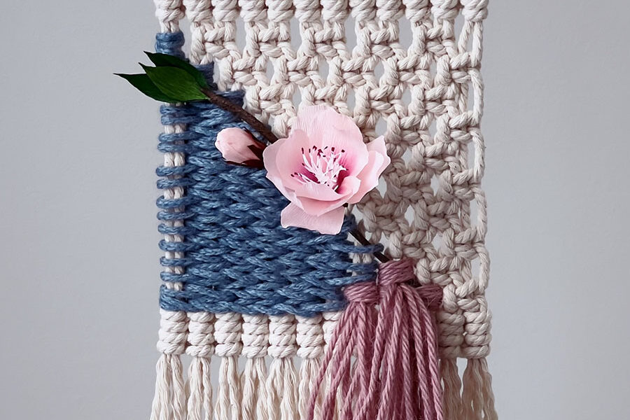 a pink flower on a rug