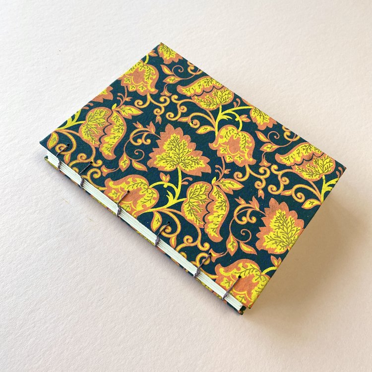 a handmade notebook with a floral pattern
