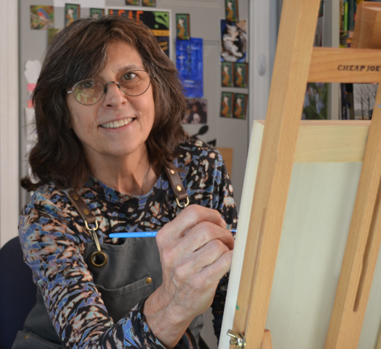 a woman painting on a canvas
