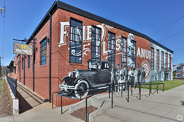 a brick building with a mural on the side
