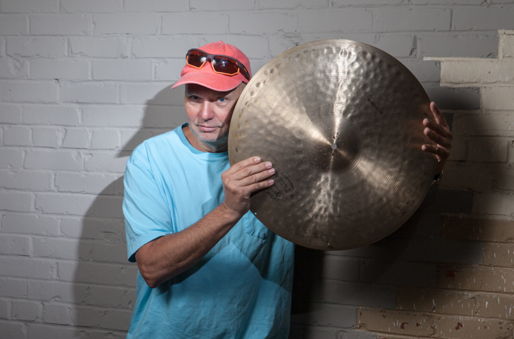 a man holding a cymbal