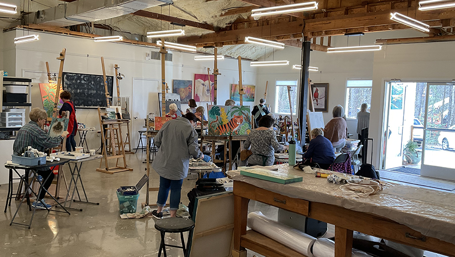 a group of people painting in a room
