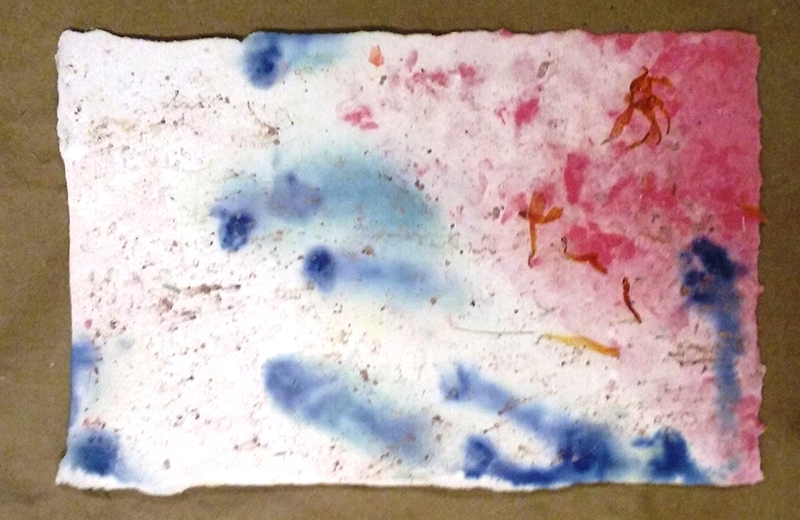 a piece of paper with blue and red paint