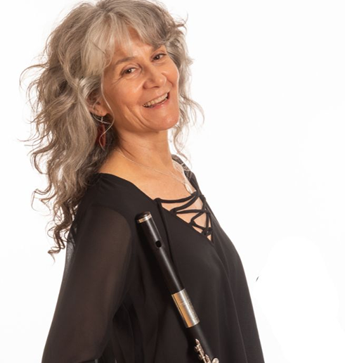 a woman with long gray hair smiling