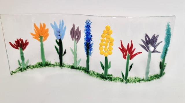 a glass flower sculpture with flowers