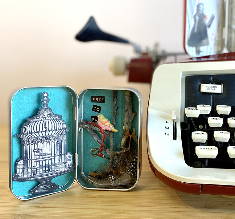 a tin can with a bird inside and a typewriter