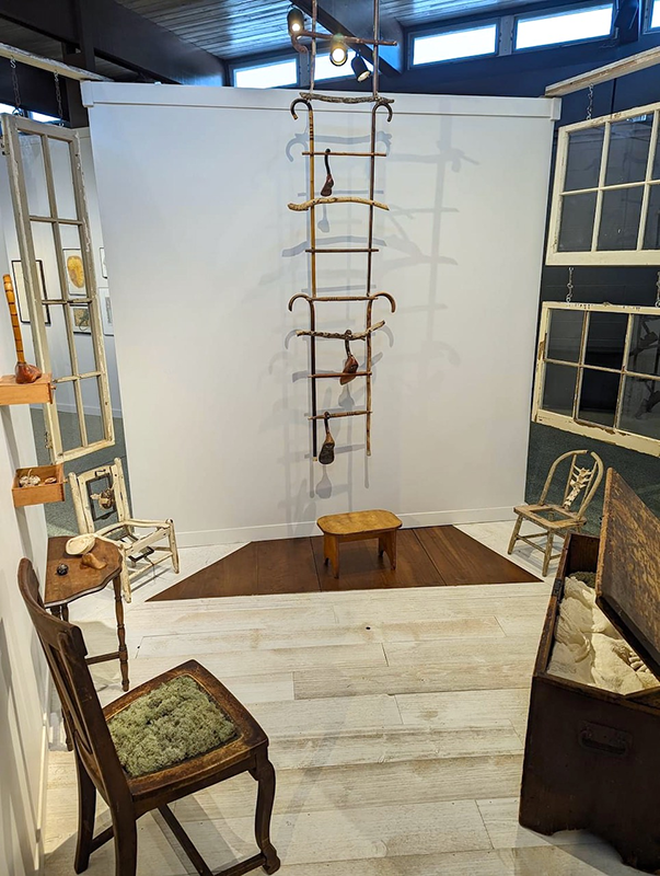 a room with a ladder and chairs