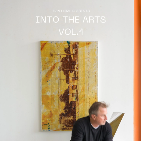 a man sitting in front of a painting
