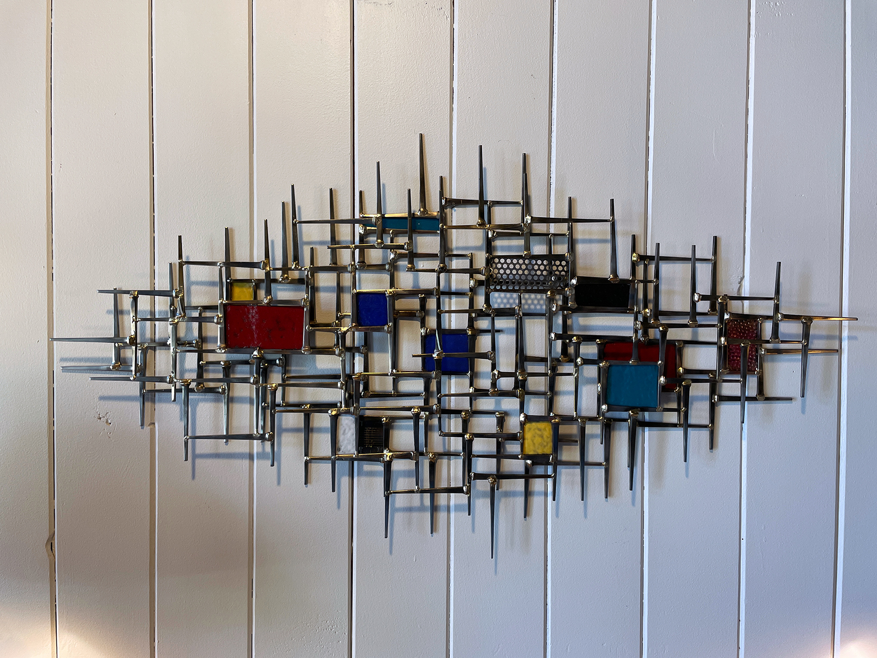 a metal art on a white surface