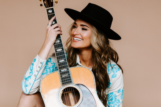 a woman with a hat and guitar