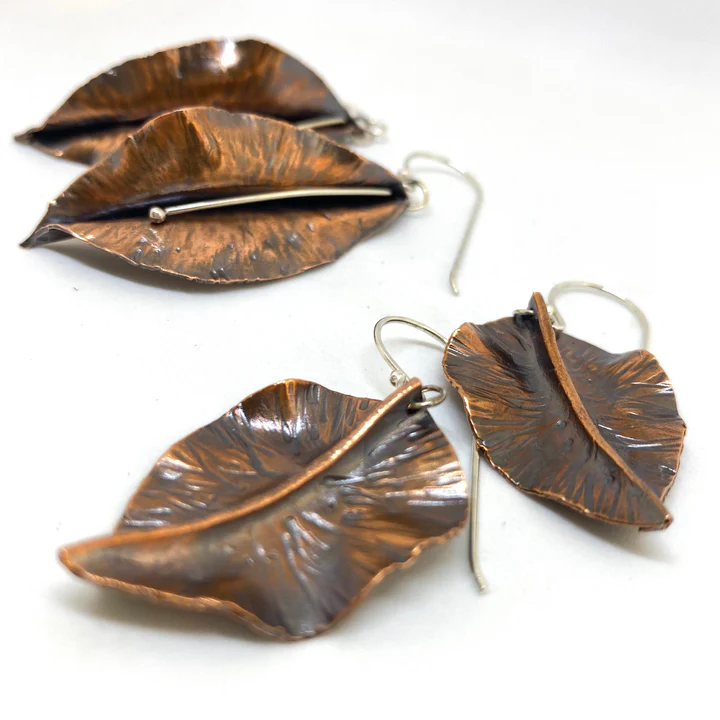 a group of earrings with leaves