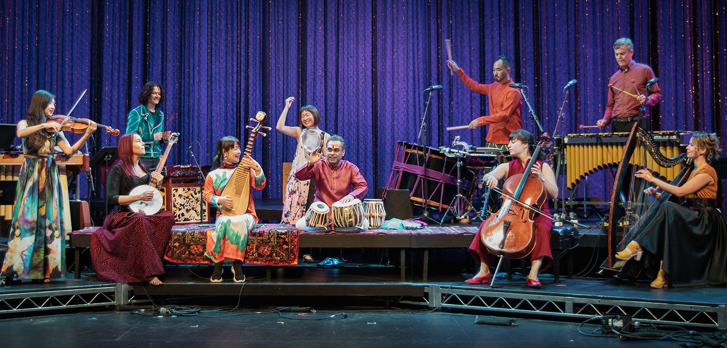a group of people playing instruments on a stage