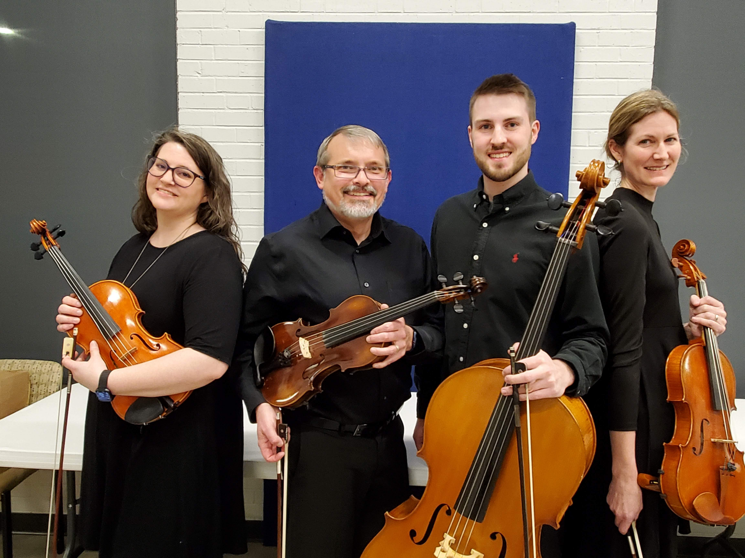 a group of people holding instruments