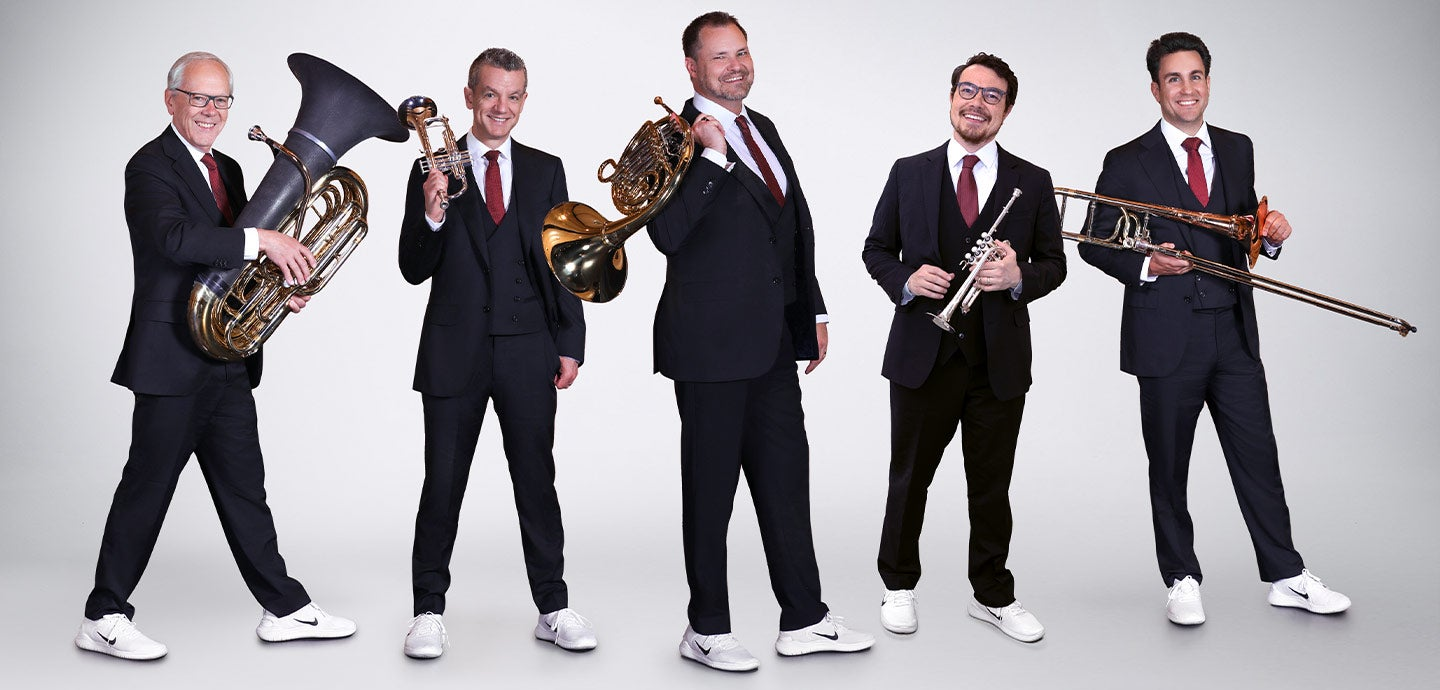 a group of men in suits holding musical instruments