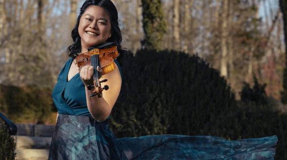 a woman holding a violin