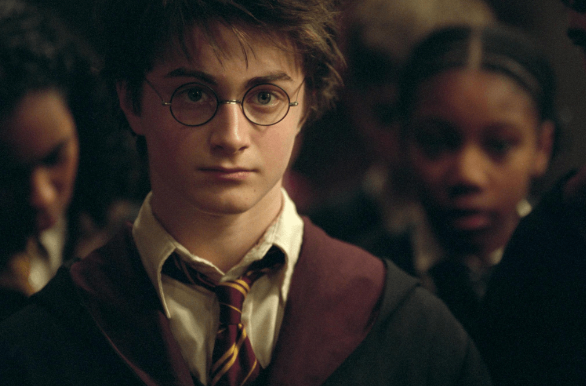 a boy wearing glasses and a robe
