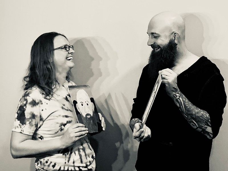 a man and woman holding a picture