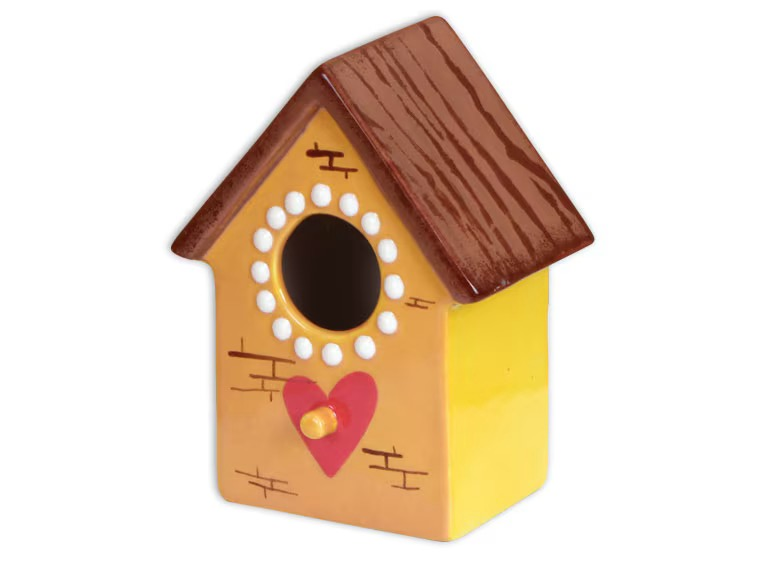 a yellow birdhouse with a heart on it