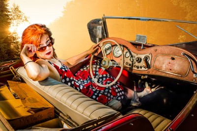 a woman in a dress in a car