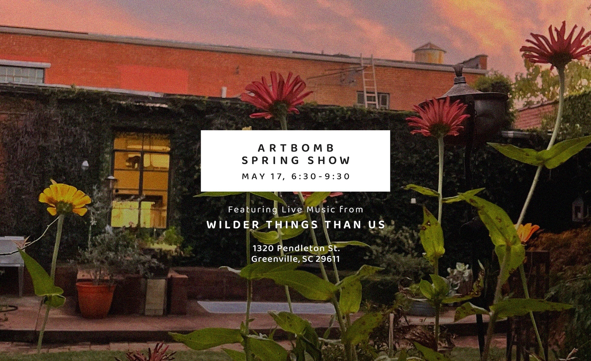 a sign with flowers in front of a building