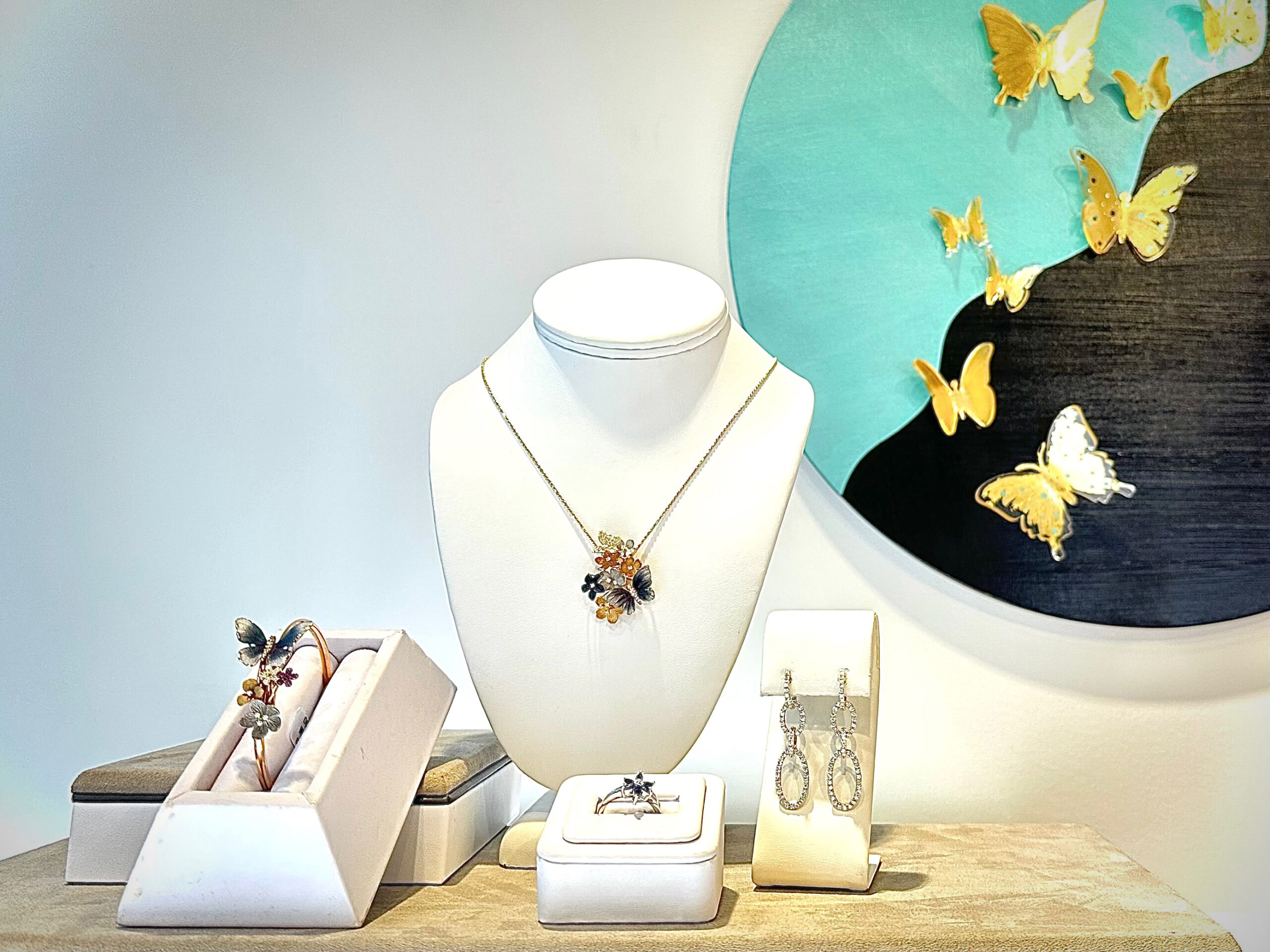 a jewelry display with butterflies on the wall