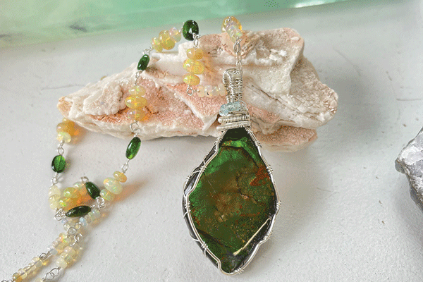 a necklace with a green stone pendant