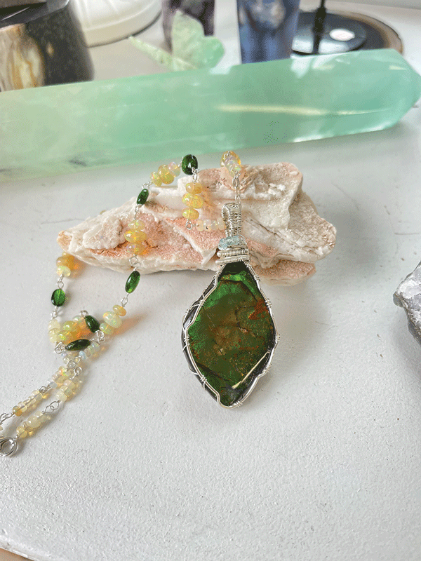 a necklace with a green stone pendant