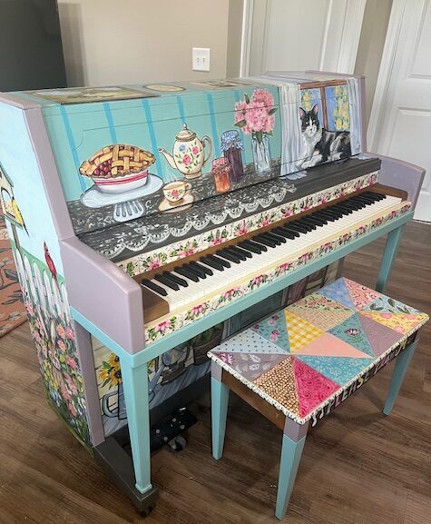 a painted piano with a stool