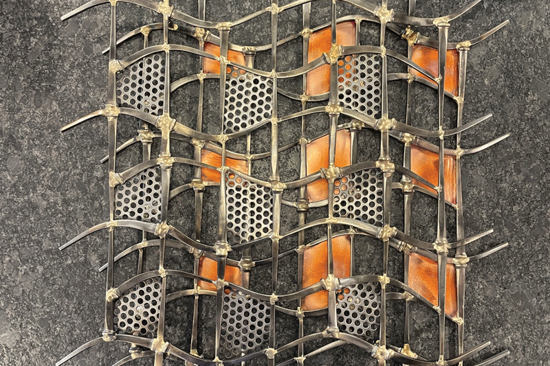 a metal grid with holes and a metal surface
