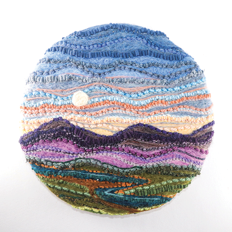 a circular object with a landscape and moon