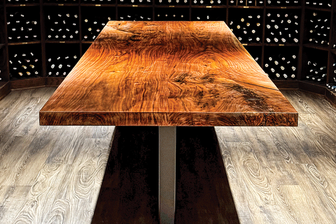 a table in a room with bottles in the back