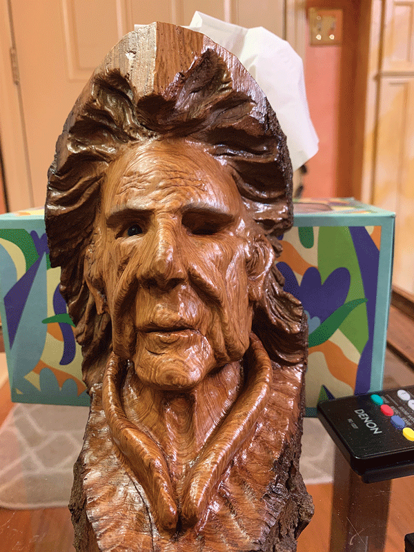 a wood carving of a man