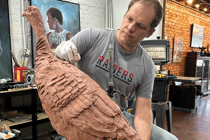 a man working on a sculpture