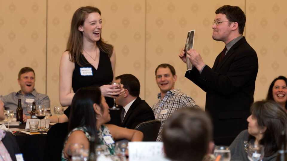 a man holding a picture of a woman
