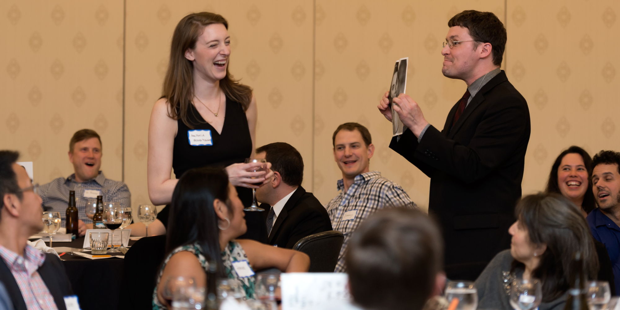 a man holding a picture of a woman